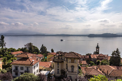 High angle view of houses by sea against sky