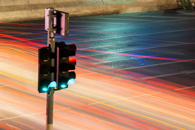 Road signal by traffic light trails at night