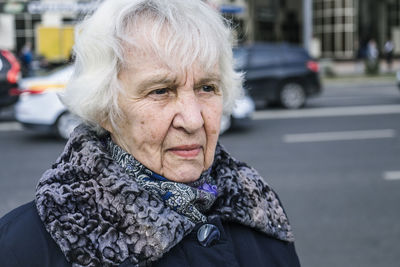 Senior woman standing in city during winter