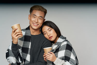 Portrait of a smiling young man drinking coffee