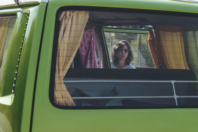 Close-up of woman seen through car window