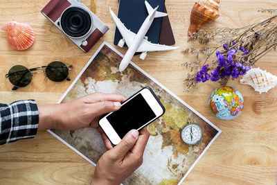 High angle view of person using mobile phone on table