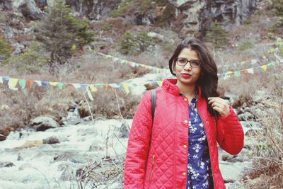 Portrait of smiling young woman standing outdoors