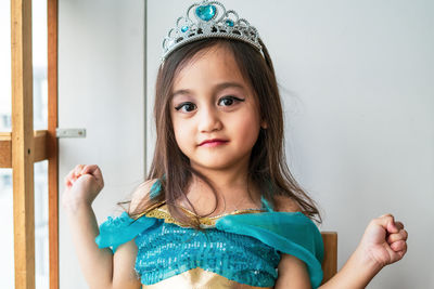 Achild girl dressed in arabian princess costume against white background. natural light.