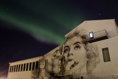 Low angle view of statue against sky at night