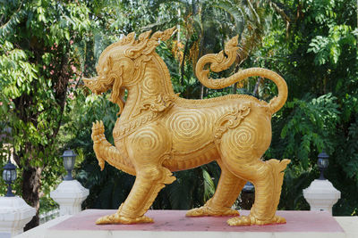 View of lion statue against trees