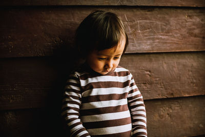 Rear view of boy looking at camera