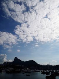 Sailboats moored in sea against sky