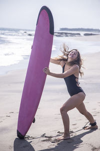 Full length of young woman on beach