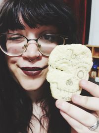 Portrait of woman holding cookie
