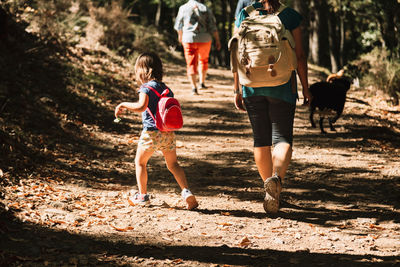 Mother and daughter hiking in forest