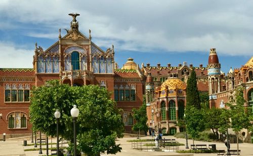 Facade of historic building against cloudy sky