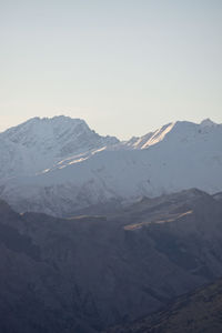 Scenic view of snowcapped mountains against clear sky