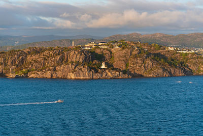 Scenic view of sea and mountains against sky