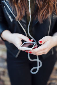 Close-up of female hands holding mobile phone