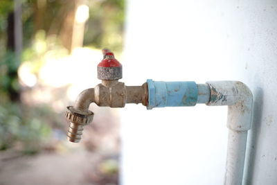 Close-up of fire hydrant against wall