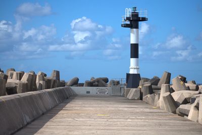 Steps leading towards lighthouse against sky