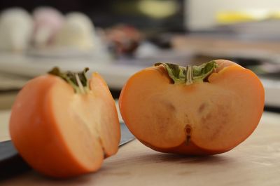 Close-up of orange fruits on cutting board