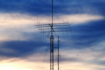 Low angle view of electricity pylon against sky