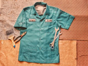 High angle view of uniform with work tools 