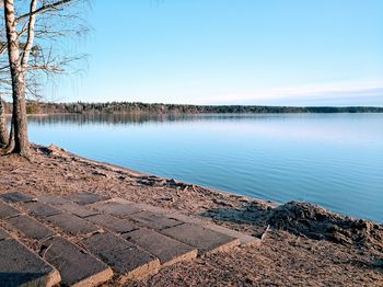 Scenic view of lake against clear blue sky