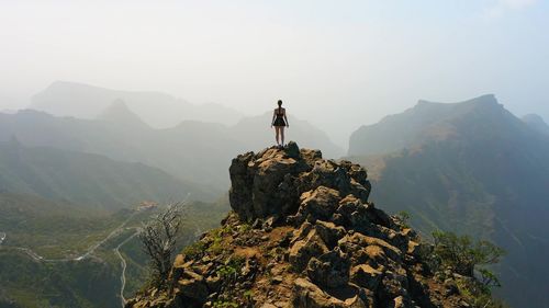 Rear view of man walking on mountain