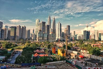 Panoramic view of buildings in city against sky