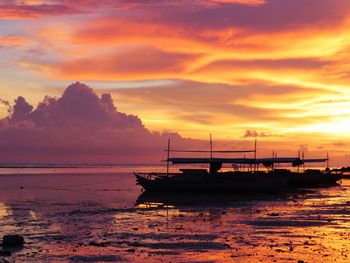 Scenic view of sea against orange sky