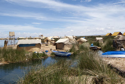 Boats moored in river against sky