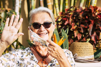 Portrait of smiling woman wearing sunglasses