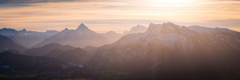 Scenic view of snowcapped mountains against sky during sunset