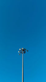 Low angle view of street light against clear blue sky