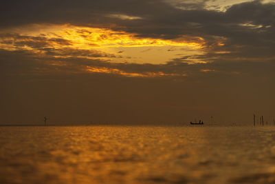 Scenic view of sea against orange sky