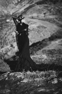 Woman standing on grassy field