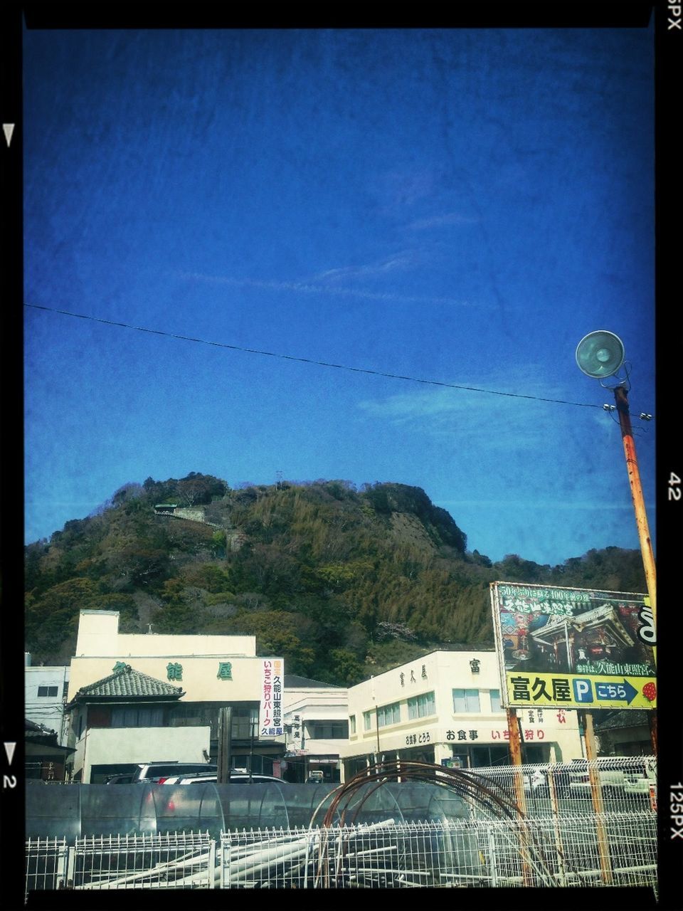 transfer print, auto post production filter, building exterior, built structure, architecture, clear sky, tree, sky, mountain, copy space, outdoors, transportation, blue, day, communication, no people, nature, city, house, low angle view