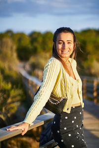 Portrait of smiling young woman standing outdoors