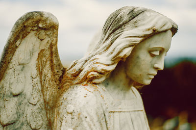 Close-up of angel statue in cemetery