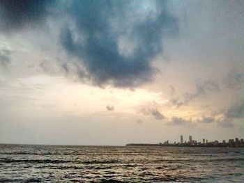 Scenic view of sea against cloudy sky