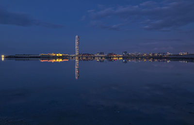 Scenic view of lake against sky at night