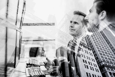 Side view of man looking through window