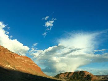 Scenic view of rocky mountains against blue sky