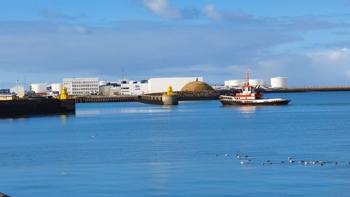 Boat entering the harbour of reykjavík with blue sea and skies 