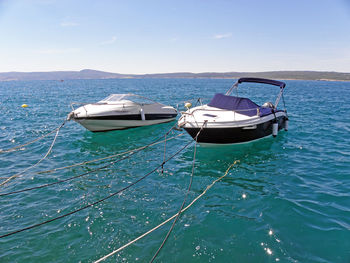 Boats moored in sea