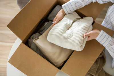 Low section of woman holding gift box