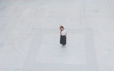High angle view of woman standing against wall