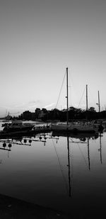 Sailboats in lake against clear sky