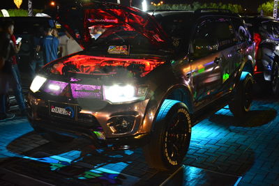 Cars parked on road at night