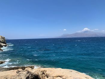 Scenic view of sea against blue sky