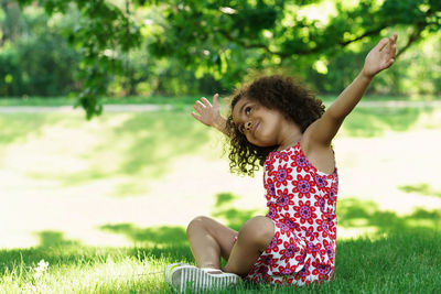 Girl sitting on grass at park