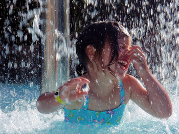 Close-up of happy girl in swimming pool